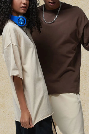 Raw-edge boxy tee in tan with relaxed fit and short sleeves.
