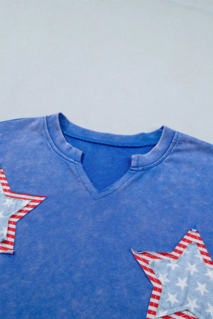 Blue cotton t-shirt with notched neck and patriotic star appliqués.