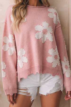 Blush pink knit sweater with white floral appliques and pearl embellishments.