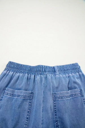 Maternity jeans in light blue denim with elastic drawstring waist and patch pockets.