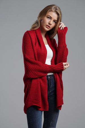 Red acrylic cocoon knit sleeve cardigan with textured sleeves and open front.