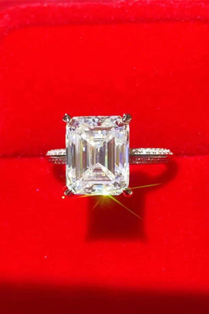 Platinum ring with emerald cut diamond and pavé band