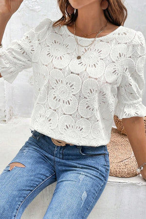 White eyelet blouse with puff sleeves and floral pattern