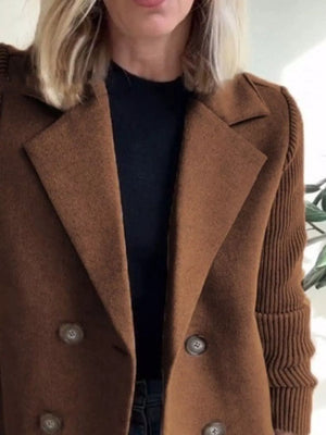 Brown double-breasted wool blend blazer with button detail and textured sleeves.