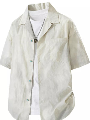 Relaxed fit camp collar shirt in apricot, buttoned, with a chest pocket and turquoise button details.