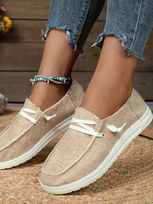 Tan textured canvas boat shoes with contrast stitching and white laces.