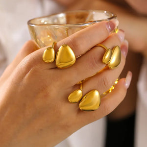 Gold bypass ring with sculptural pebble details.