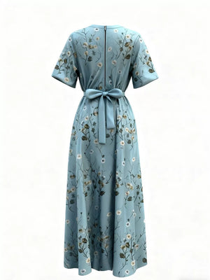 Teal floral maxi dress with short sleeves, defined waist tie, and back zipper.