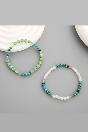 Turquoise cube and crystal beaded bracelets with light green and teal beads.