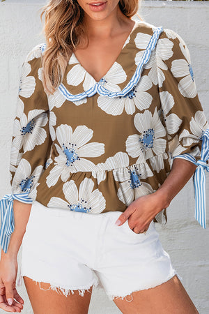 Floral print blouse in camel with a Peter Pan collar and tie sleeves.