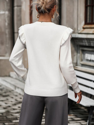 White crew neck sweater with contrast trim ruffle shoulders and long sleeves.