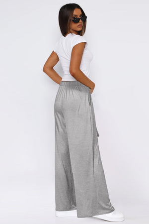 Soft drape palazzo trousers in light gray with a tie detail and elastic waist.