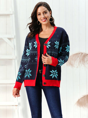 Dark blue acrylic cardigan with snowflake intarsia pattern and red trim.
