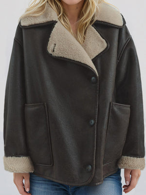 Chocolate aviator jacket with shearling trim, button front and patch pockets.
