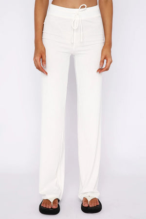 White ribbed wide leg pants with drawstring waist, styled with platform flip-flops.
