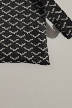 Black clutch bag with geometric pattern and wrist strap detail