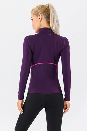 Violet athleisure zip-neck top with contrast pink seam detail and long sleeves.