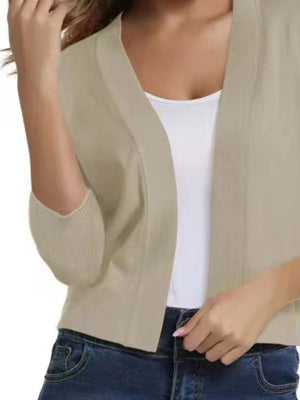 Beige cropped elbow-sleeve open-front knit cardigan with ribbed sleeves.