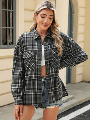 Gray plaid collared long sleeve shirt with button-down front and chest pockets.