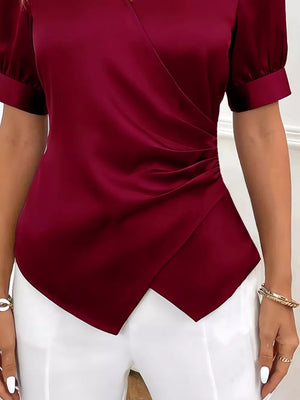 Burgundy satin surplice blouse with ruched side detail and short puff sleeves.