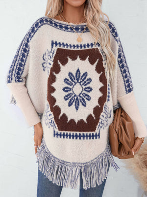 Cream acrylic poncho with Aztec motif, fringe hem, and blue trim.