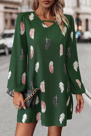 Green feather print mini dress with cutout neckline and long sleeves.