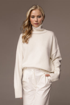 Oversized white cashmere turtleneck sweater with ribbed cuffs and hem.