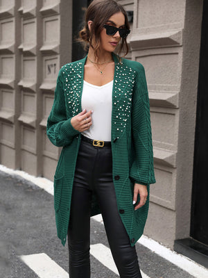 Green cable knit cardigan with pearl embellishments and button front.