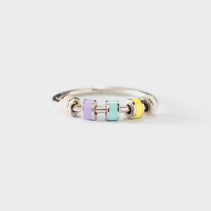 Sterling ring with pastel chromatic beads in pink, purple, blue, and yellow.