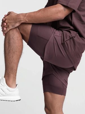 Plum purple layered performance shorts with perforated side panels and a built-in liner.