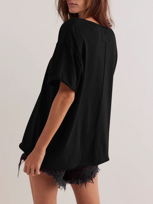 Black oversized cotton tee with seam details and short sleeves