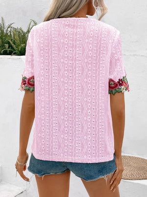 Blush pink peasant blouse with eyelet fabric and floral embroidered sleeves.