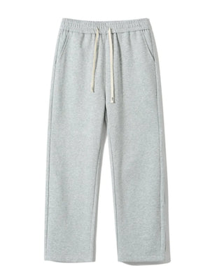 Gray sweatpants with drawstring waist and loose fit.