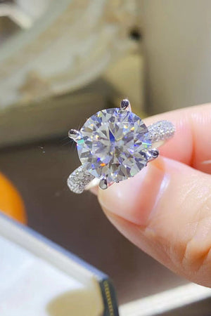 Silver pavé band round moissanite solitaire ring with a large center stone.