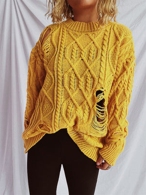 Yellow distressed cable knit sweater with ripped details and crew neck.