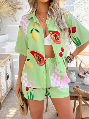 Green co-ord set with fruit and floral print, button-up shirt and shorts.