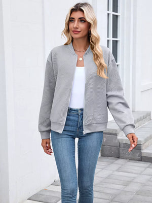 Black bomber jacket featuring zipper and geometric
