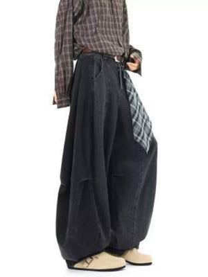 Belted wide-leg vintage wash jeans in dark denim with a plaid sash detail.