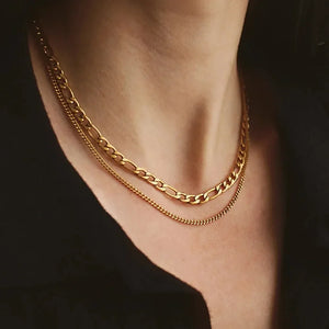 Gold dual-strand curb chain necklace with a delicate layered look.