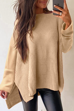 Tan ribbed knit pullover sweater with asymmetric hem and long sleeves.