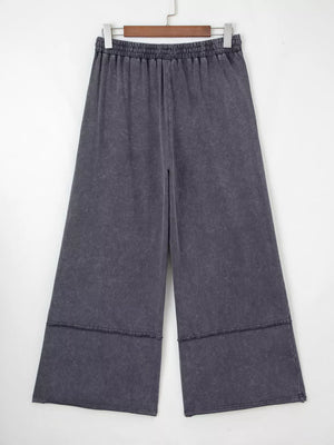 Maternity cropped wide-leg trousers in charcoal cotton with elastic waist and raw hem detail.