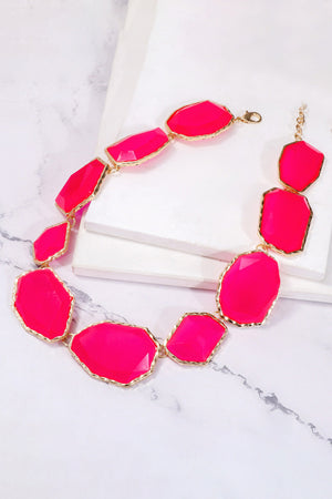 Prismatic resin stone collar necklace in hot pink with gold trim and chain.