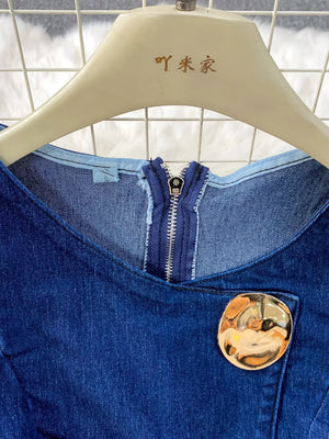 Dark blue cotton denim vest with asymmetrical button detail and silver zipper.