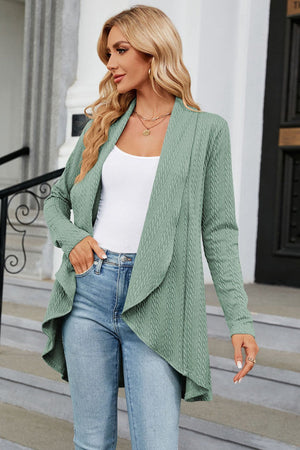 Sage green cable knit cardigan with drape front and open neckline.
