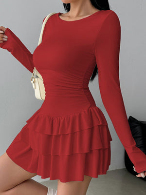 Red long sleeve mini dress with tiered ruffle hem and ruched sides.