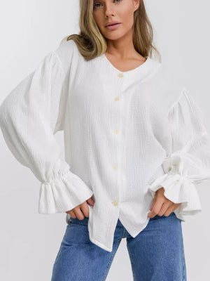White textured puff sleeve blouse with ruffled cuffs and button front