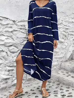 Navy abstract striped v-neck maxi dress with long sleeves and a side slit.