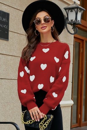 Red sweater with white heart pattern, balloon sleeves, and crew neck.