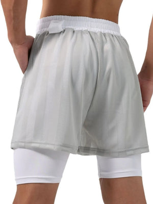 Gray layered mesh performance shorts with white built-in compression shorts.