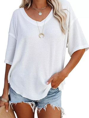White waffle knit relaxed v-neck t-shirt with short sleeves and a curved hem.